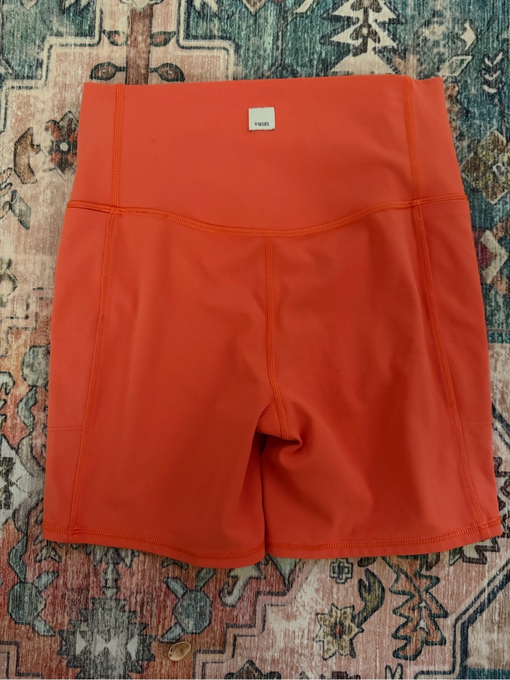 Vuori High-Rise Bike Shorts in Coral Orange